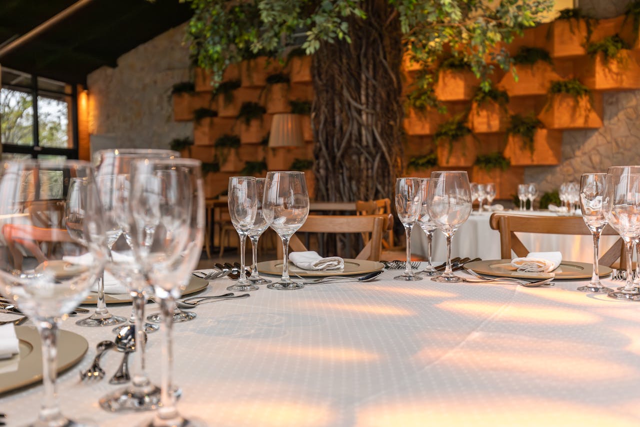 Elegant table setting in a restaurant with wine glasses and stylish decor.